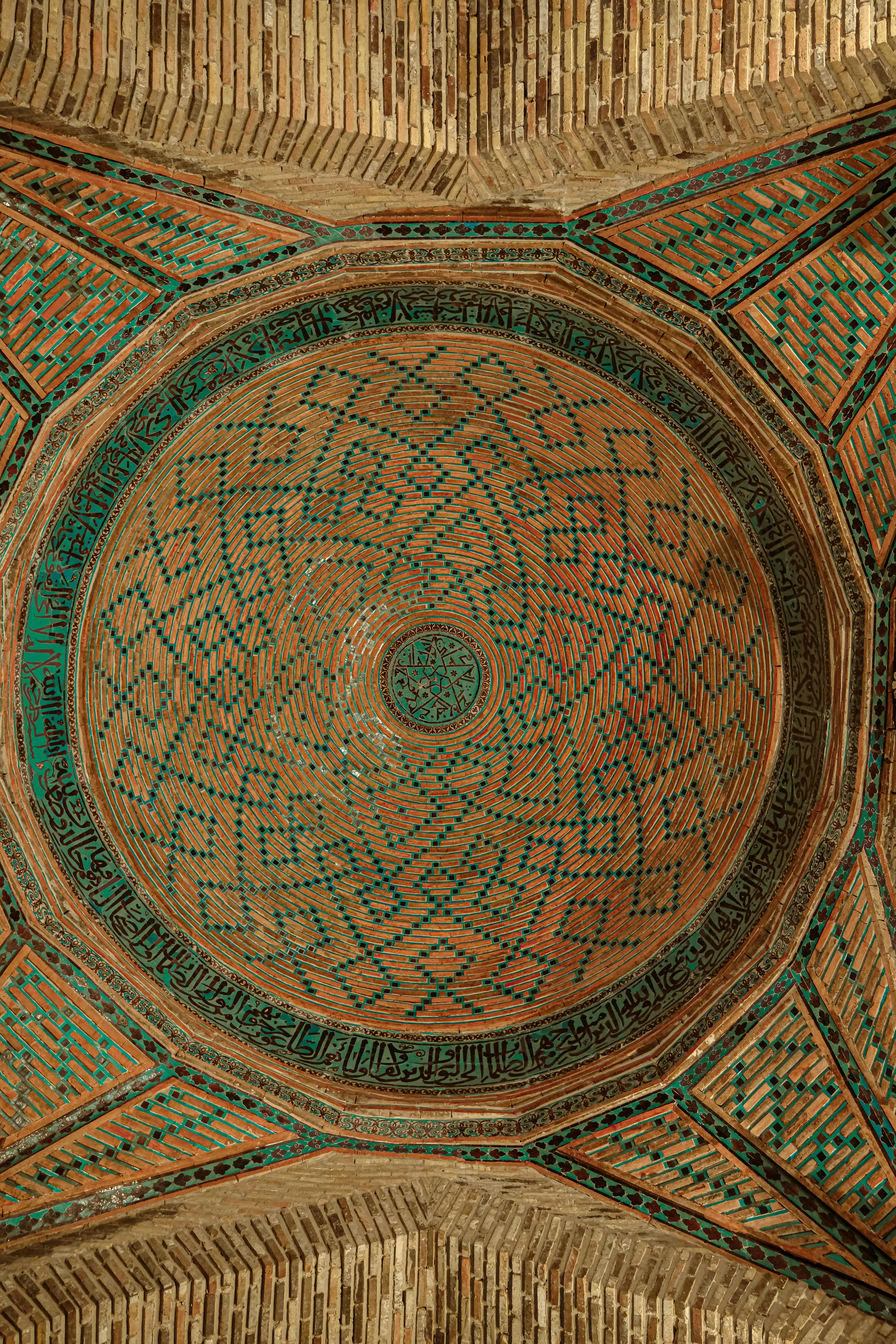 Stunning ceiling with intricate geometric patterns and calligraphy in a historical building.