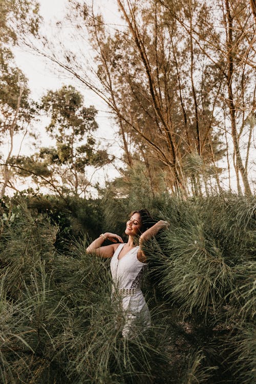 Free Woman in White Sleeveless Dress Standing Outdoors Stock Photo