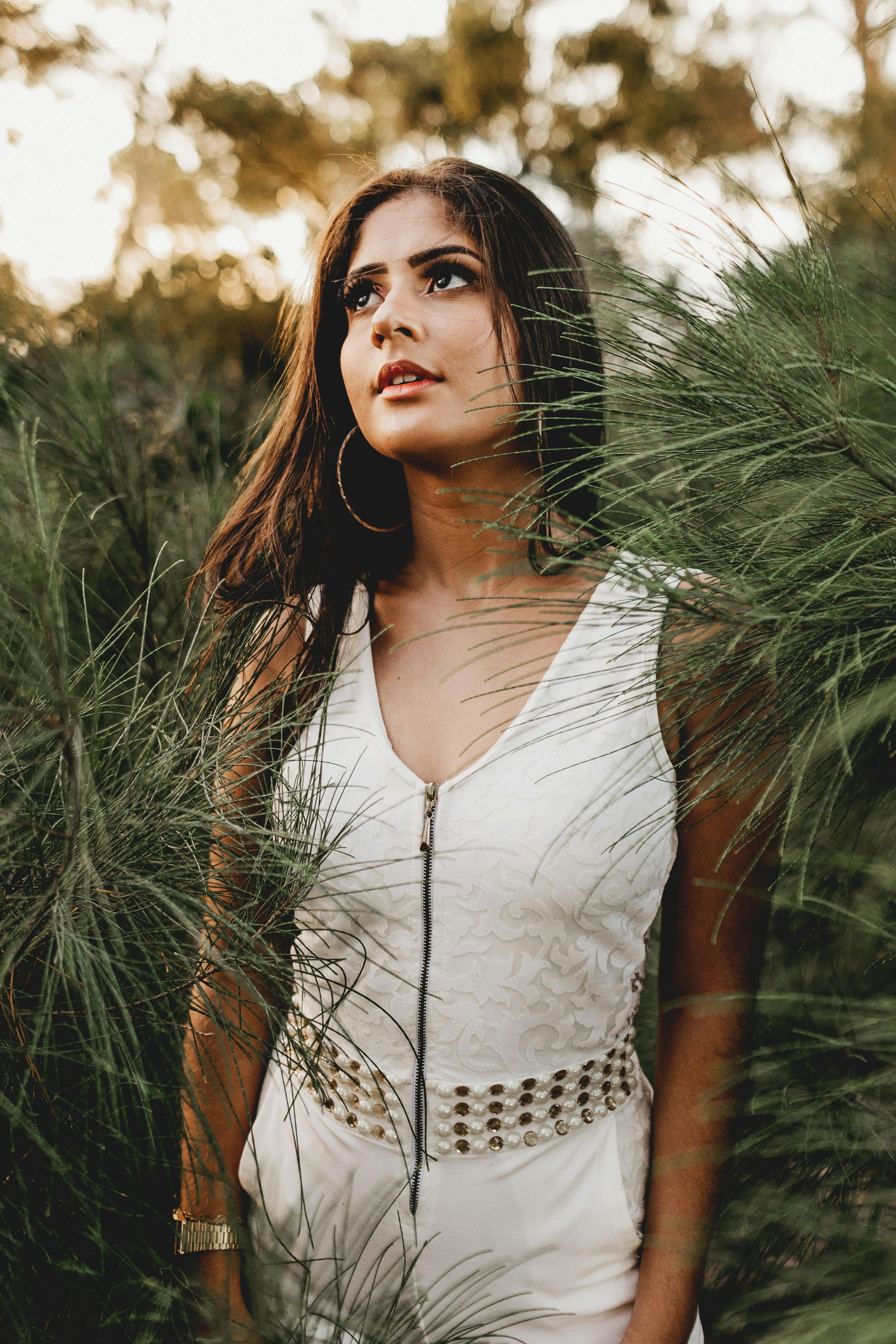 Woman Wearing White Dress Surrounded by Green Plants · Free Stock