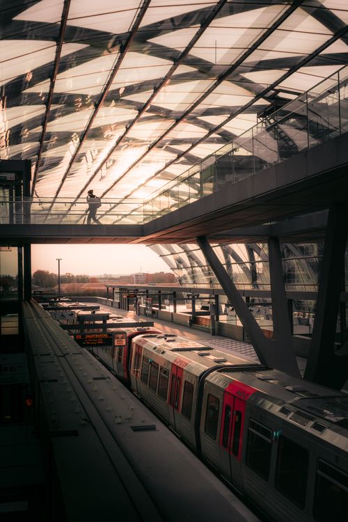 Free Elegant architecture and trains at a Hamburg station with a sunset view. Stock Photo