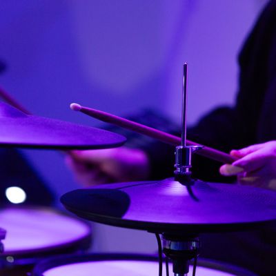 Drummer under violet light - photo by Biekir Litovchenko on Pexels