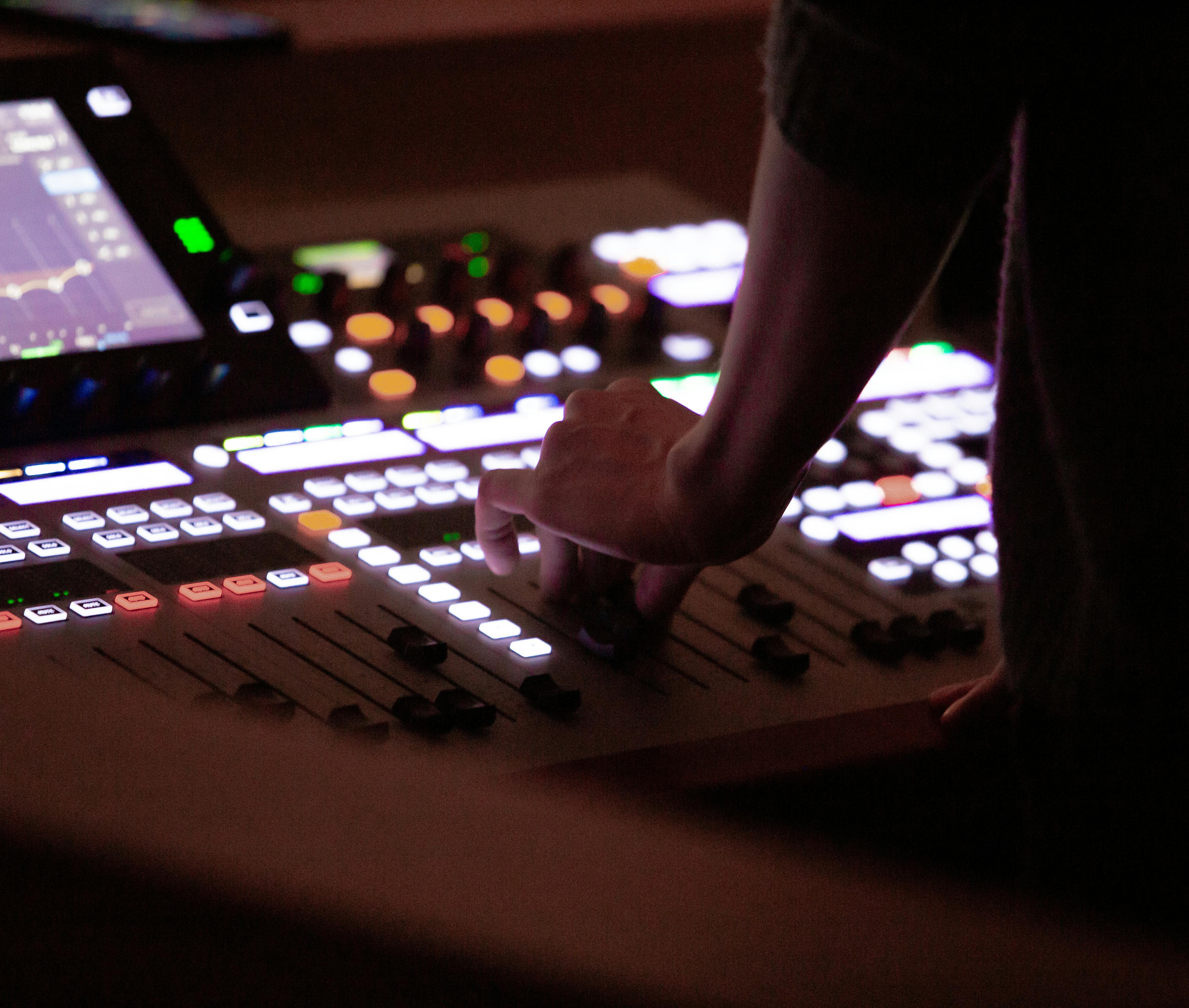 Sound engineer adjusting mixer controls