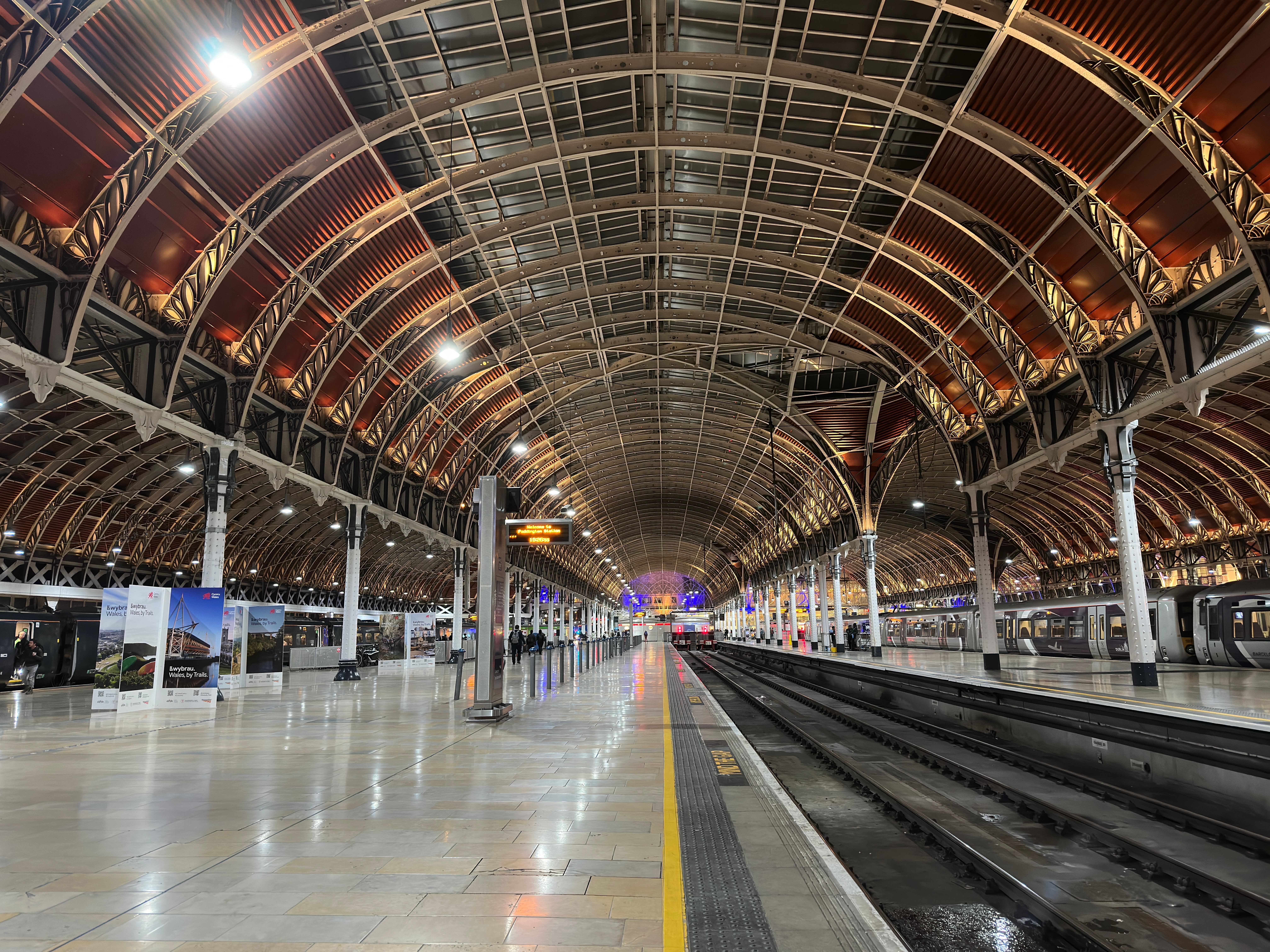 A mesmerizing view of the historic Paddington Station's grand interior architecture at night.