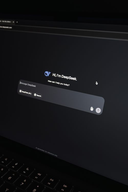 A laptop screen displaying an AI chat interface in a modern workspace, representing AI video and content creation tools in daily creator workflows.