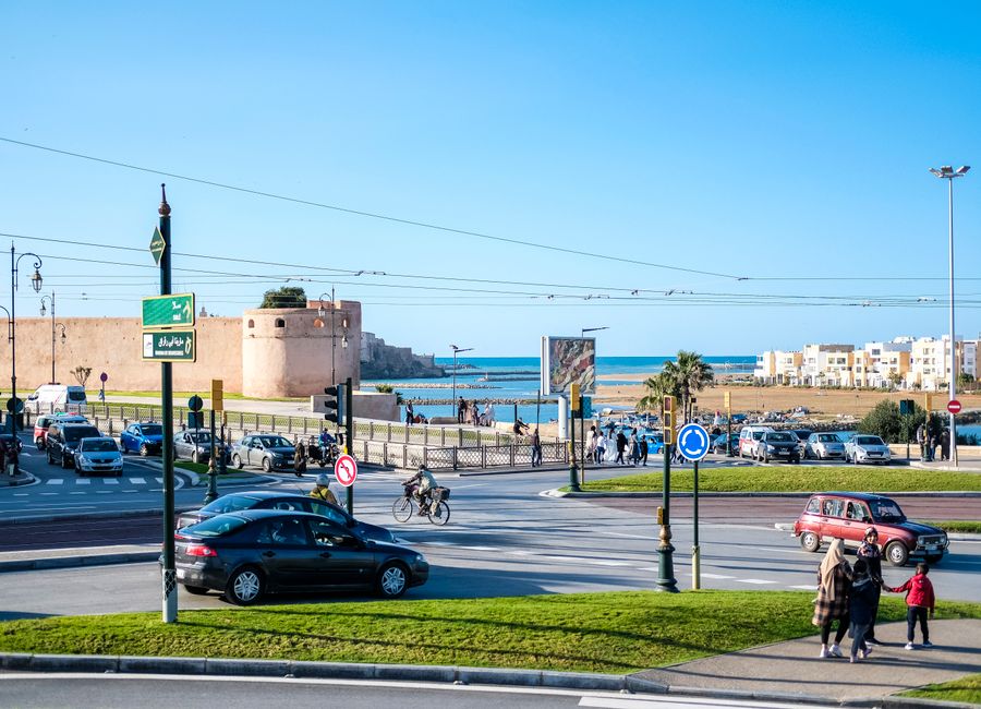 Vibrant street scene in Rabat, Morocco, with historical architecture and coastal view.
