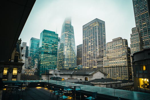 Misty New York City skyline showcasing iconic skyscrapers from a rooftop perspective.
