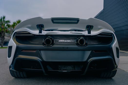 Close-up of the rear design of a powerful sports car parked outdoors.