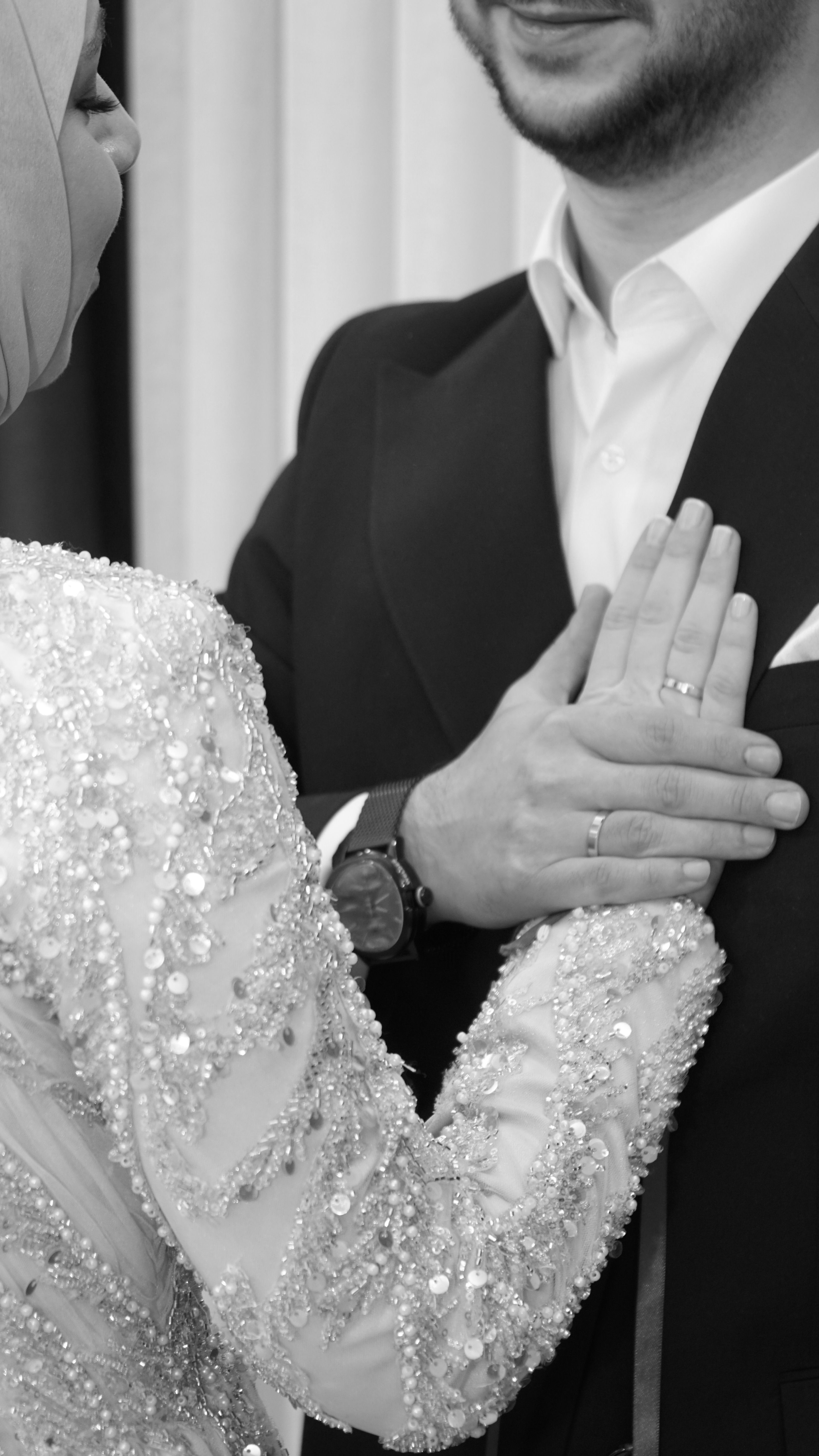 Elegant wedding scene featuring a couple in a loving embrace, showcasing detailed attire.