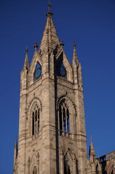 Ornate Gothic cathedral tower in Guadalajara, Mexico, captured against a clear blue sky.