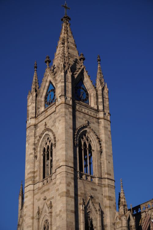 Free Ornate Gothic cathedral tower in Guadalajara, Mexico, captured against a clear blue sky. Stock Photo