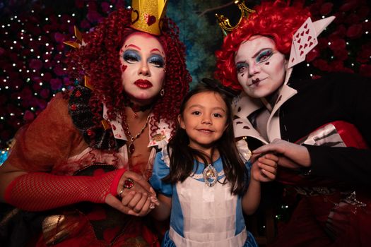 Vibrant portrait of Alice in Wonderland cosplay with detailed art makeup and costumes.