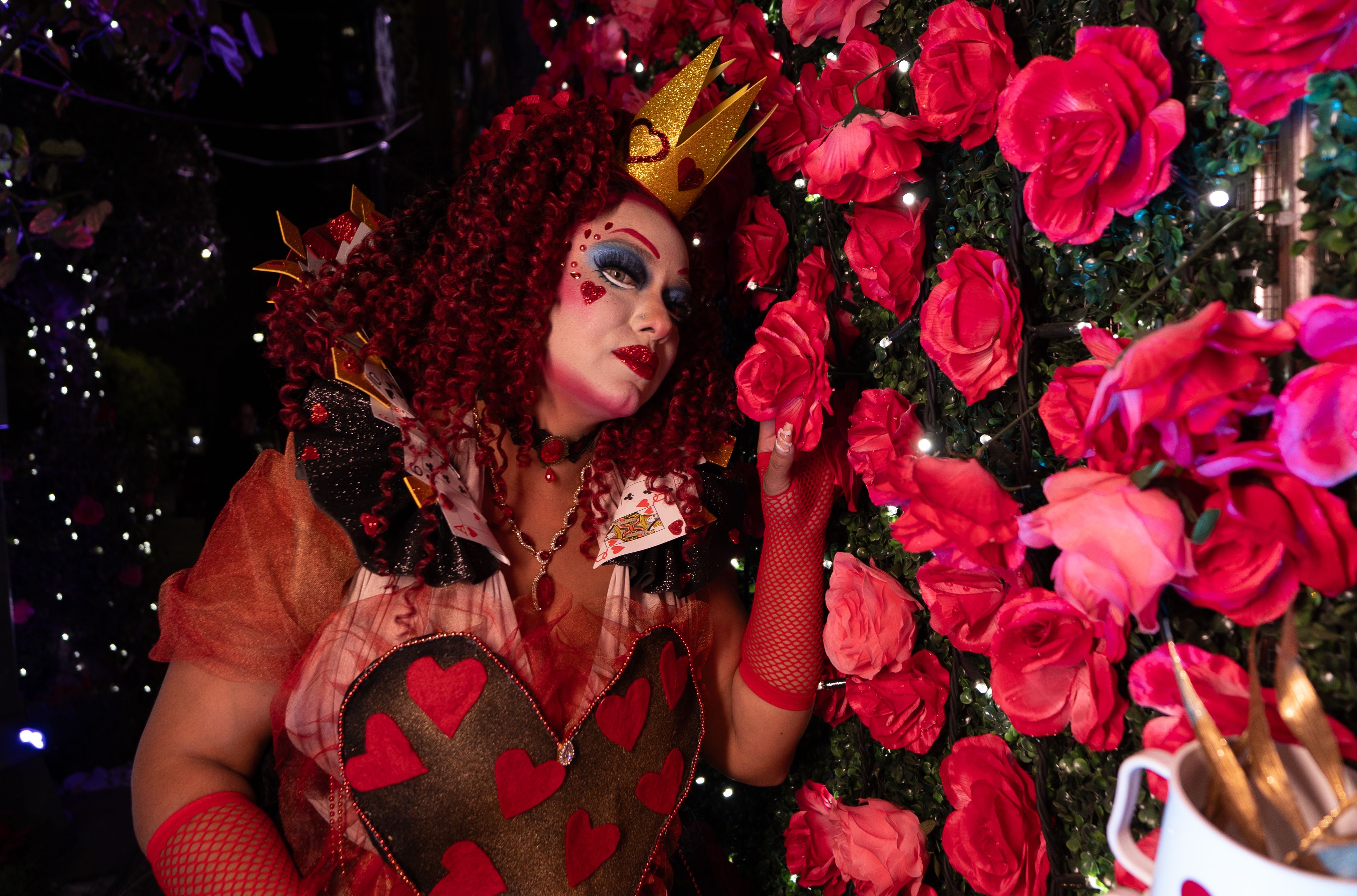 [ColoSach]-vibrant-queen-of-hearts-cosplay-amidst-a-rose-garden-with-intricate-artistic-makeup.