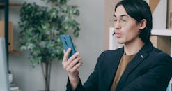 Professional man using smartphone in office setting