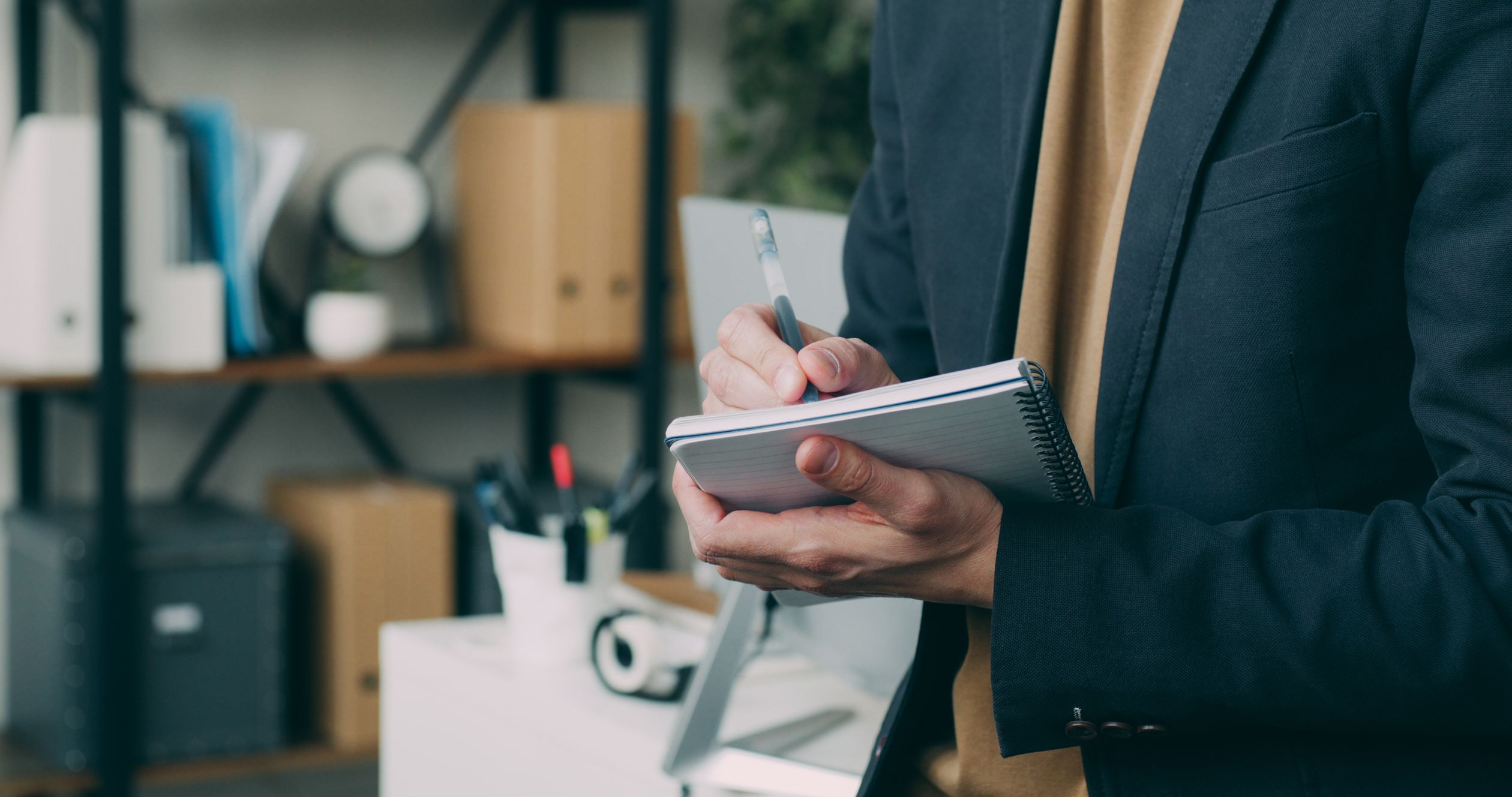 Business Professional Taking Notes in Office · Free Stock Photo