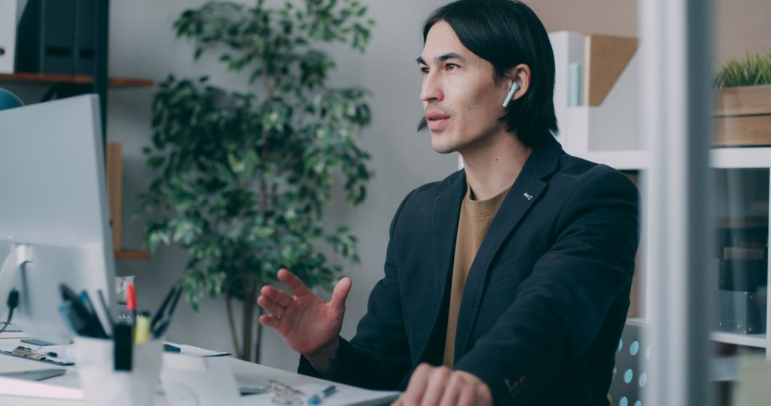 Engineer at a desk explaining how the sign-in flow works — photo by Vitaly Gariev on Pexels