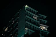 Modern building exterior at night with lights