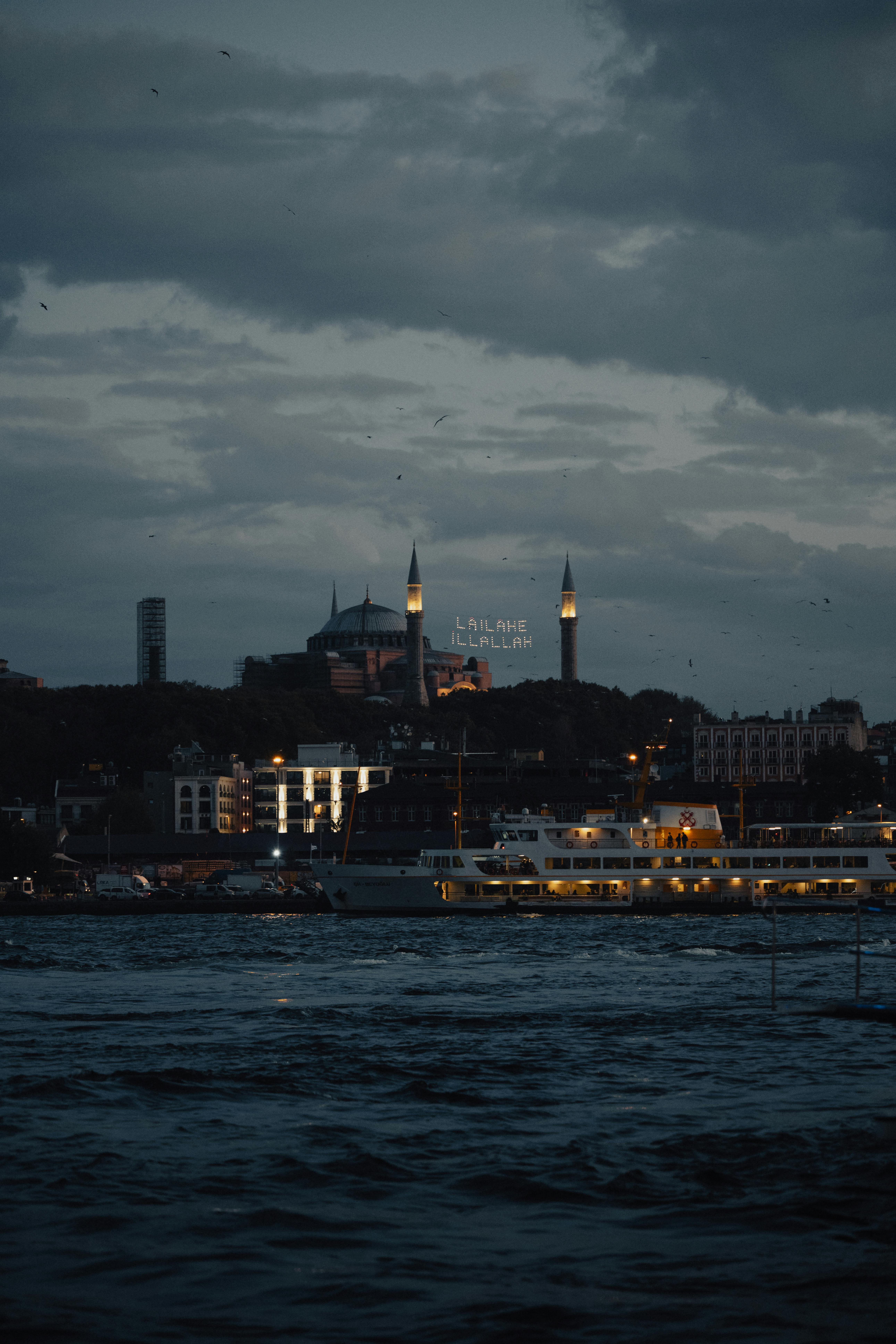 Moody evening shot of Istanbul featuring Hagia Sophia, Bosphorus, and cityscape lights.