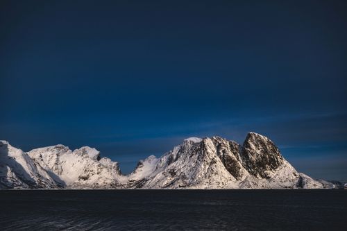 Free Scenic view of snow-covered mountains beneath a clear blue sky, conveying tranquility and majesty. Stock Photo