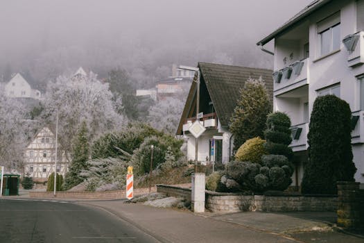 Quaint frosty village street showcasing traditional European architecture in winter.
