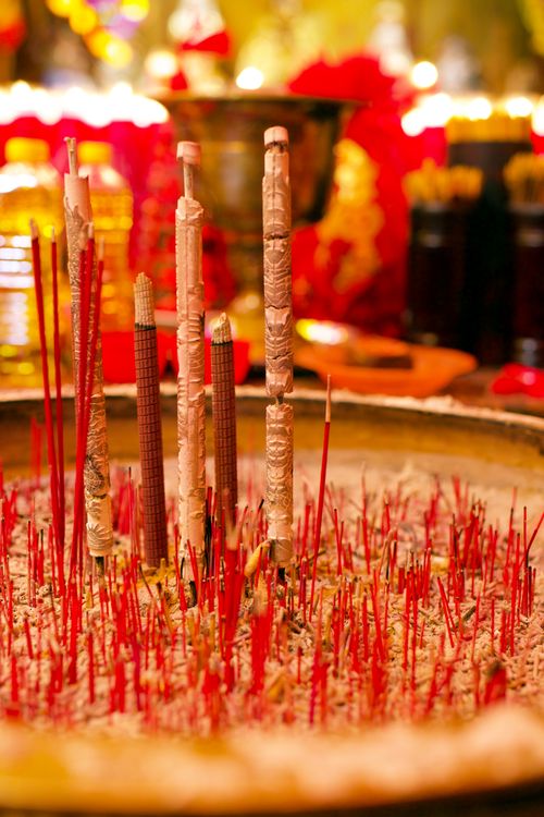 Free Burning incense sticks in a ceremonial bowl, symbolizing tradition and celebration during Chinese New Year. Stock Photo