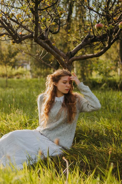 Young Woman Relaxing Under Apple Tree in Orchard · Free Stock Photo
