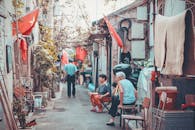 Two Women Sitting on Alley