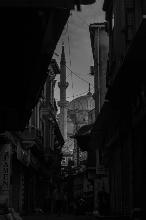 Free Dramatic black and white view of Istanbul's iconic mosque through narrow street, evoking a timeless atmosphere. Stock Photo