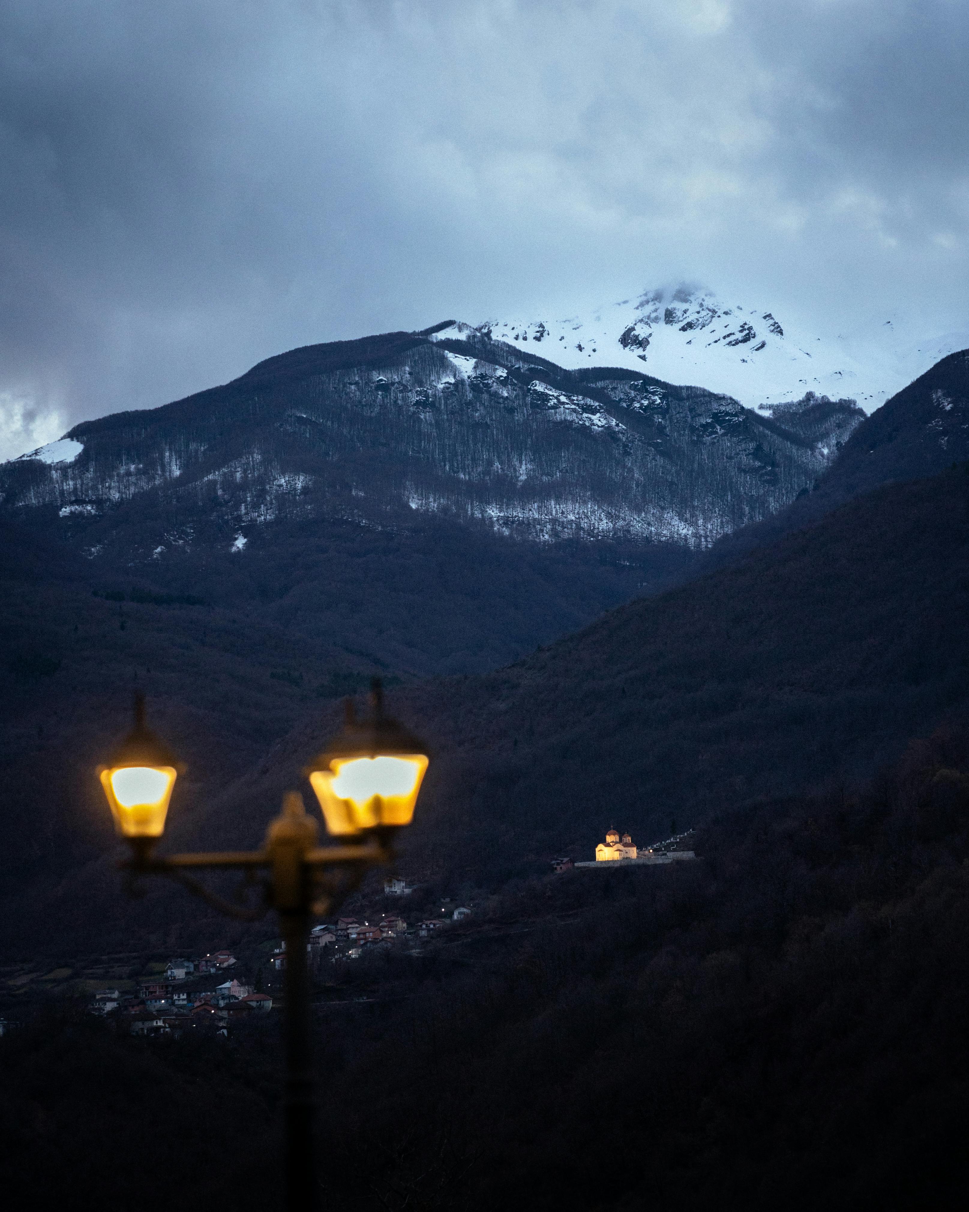 Enchanting winter evening view of Radostusha and snowy mountains in North Macedonia.