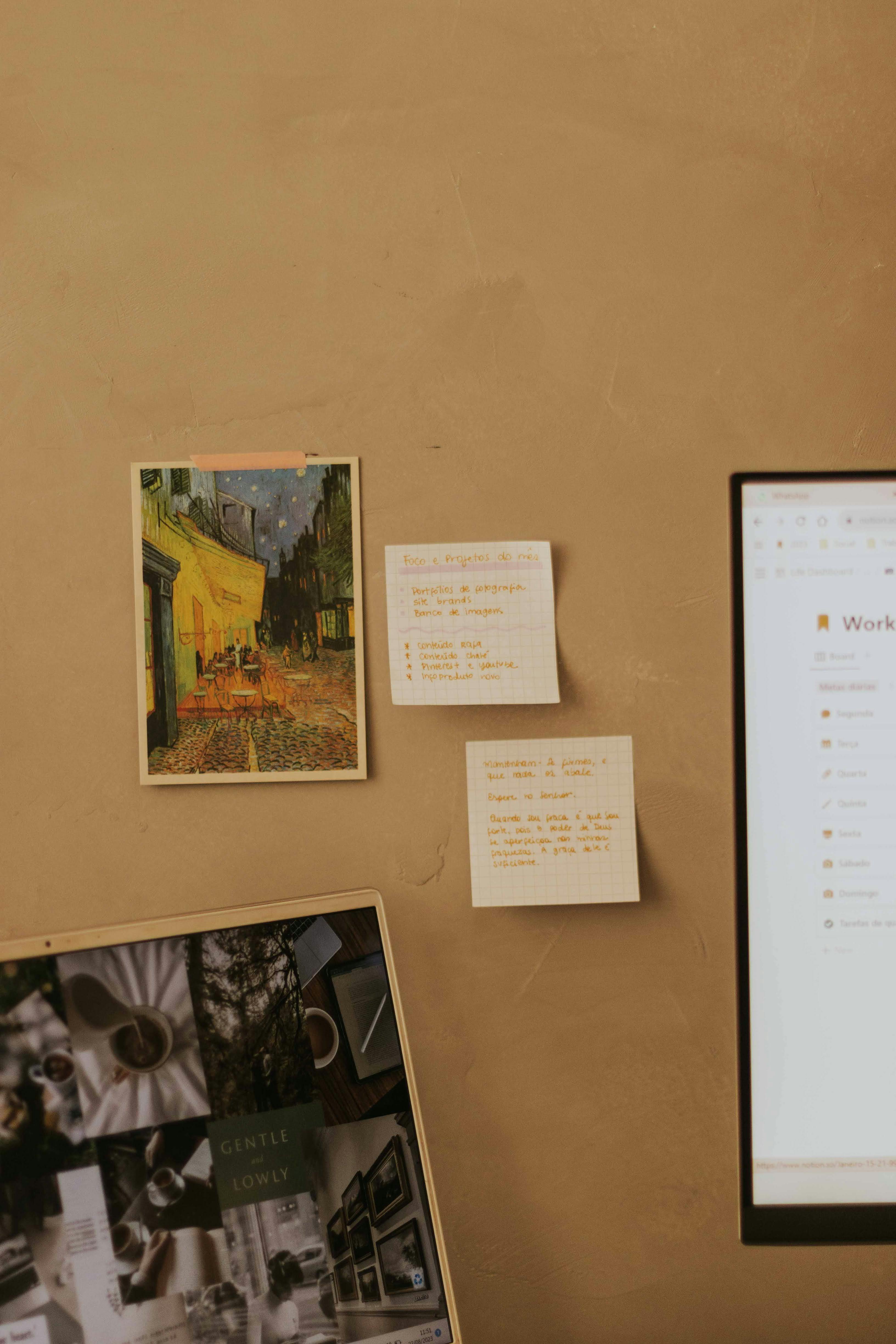 A warm toned workspace featuring sticky notes and an art print, ideal for inspiration.
