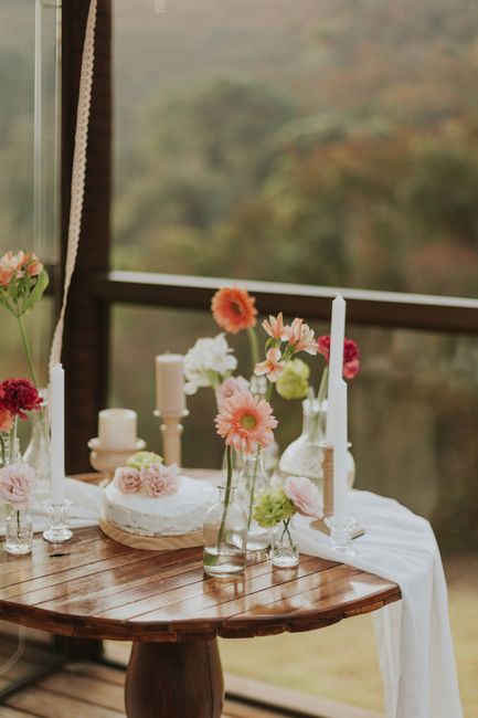 Beautiful rustic table setting with flowers and candles, perfect for intimate gatherings.