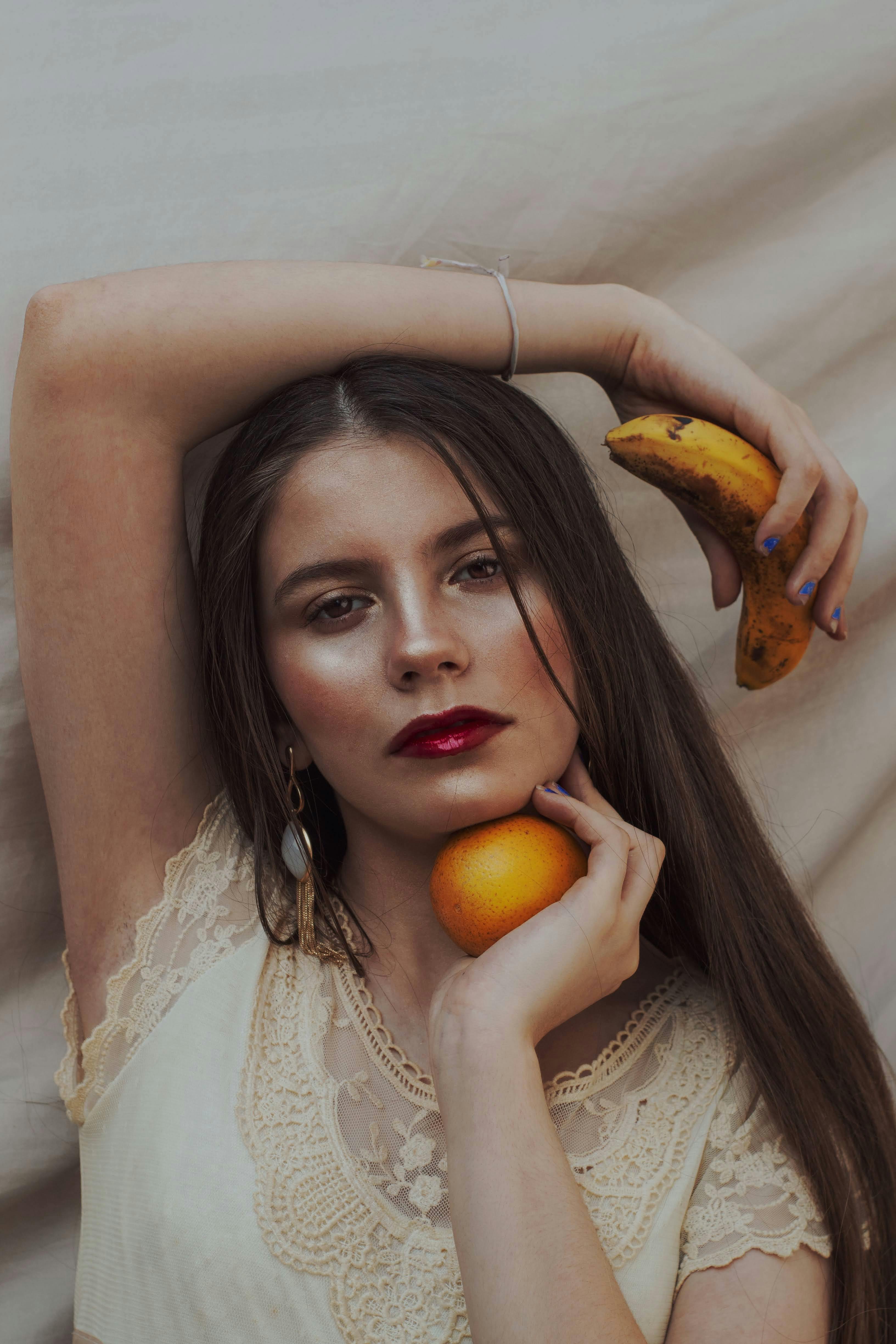 portrait of woman with fruits in hand