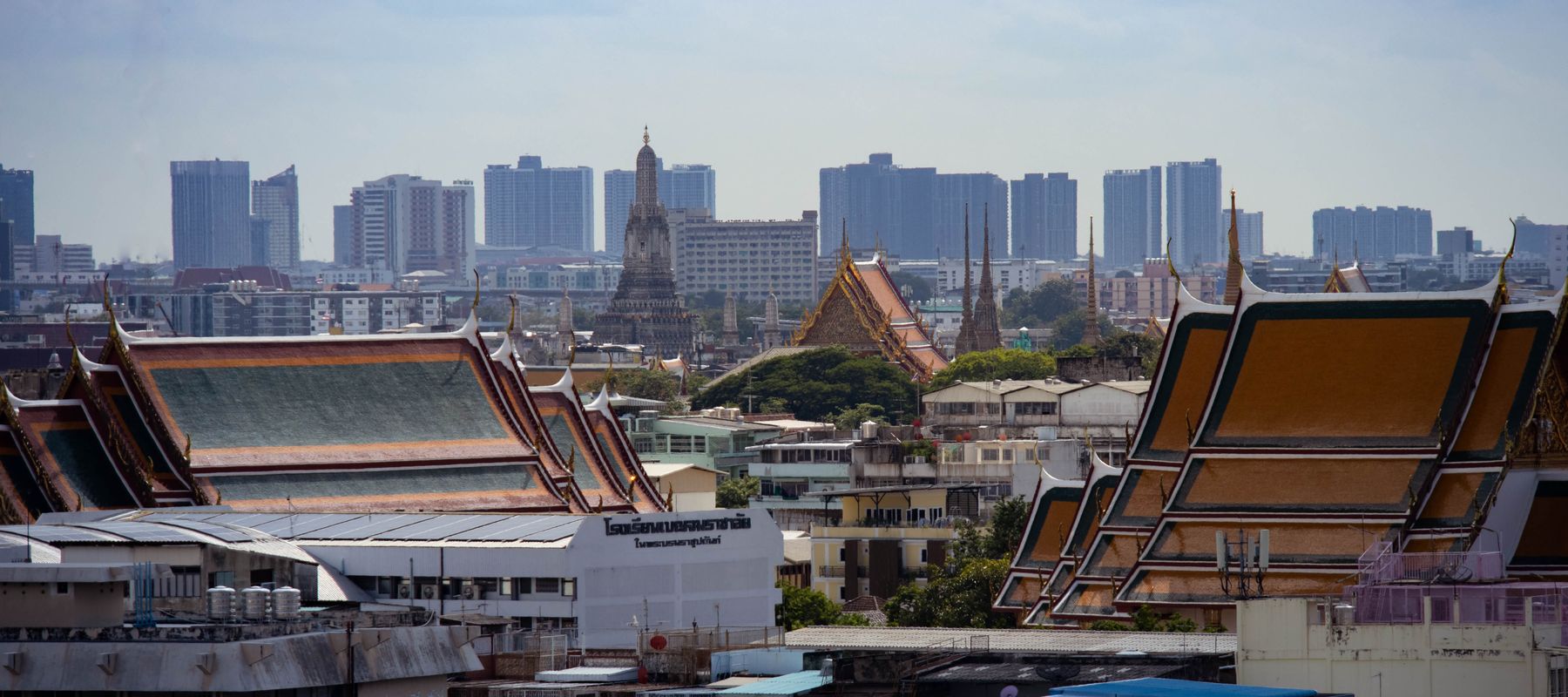 Skyline view of Bangkok highlighting traditional Thai architecture amidst modern buildings.