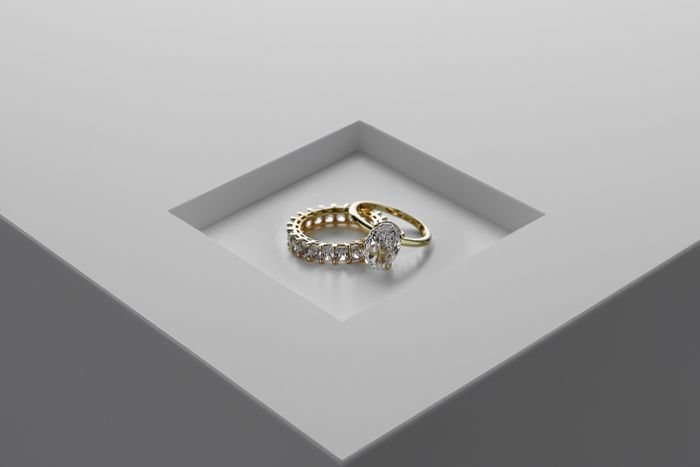Gold and diamond rings on a pale surface