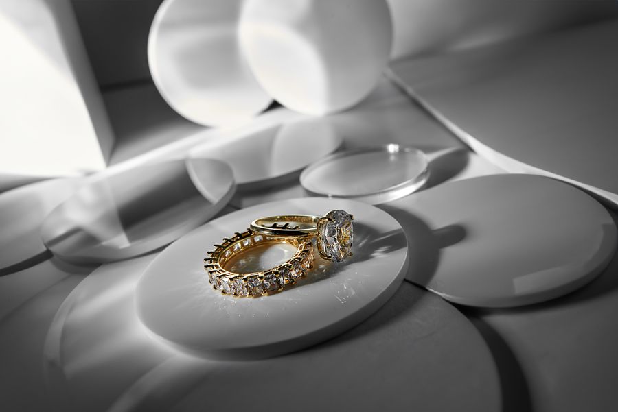 Gold and diamond rings on a modern surface