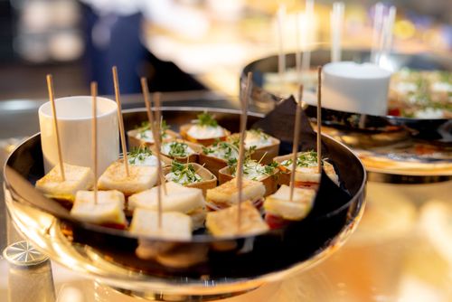 Free Delicious canapes elegantly arranged on a platter, perfect for upscale events and gatherings. Stock Photo