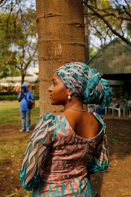 Free Woman in traditional Nigerian attire in Abuja park setting Stock Photo