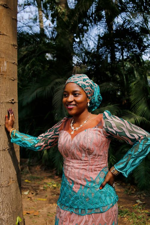 Free A woman in vibrant Nigerian traditional dress enjoying nature in Abuja. Stock Photo