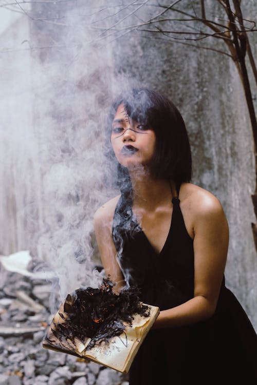 Free Woman Holding Book on Fire Stock Photo