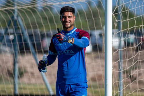 Free Goalkeeper smiling and giving thumbs up on a sunny day at a soccer field. Stock Photo