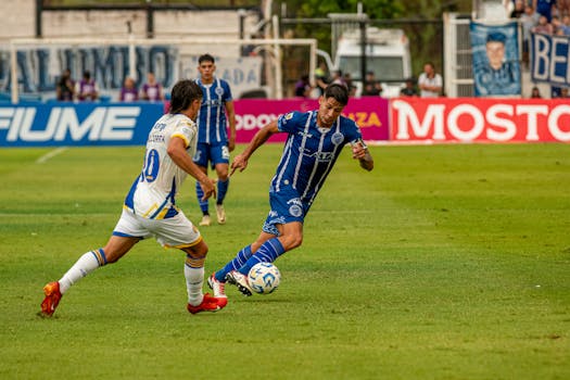 Players in action during a competitive soccer game on a green field.
