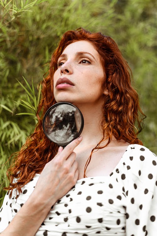 Free Woman Holding Black Framed Magnifying Glass Stock Photo