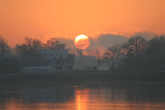 Enjoy a serene winter sunrise over Stamford's waterfront, highlighting tranquil water reflections.