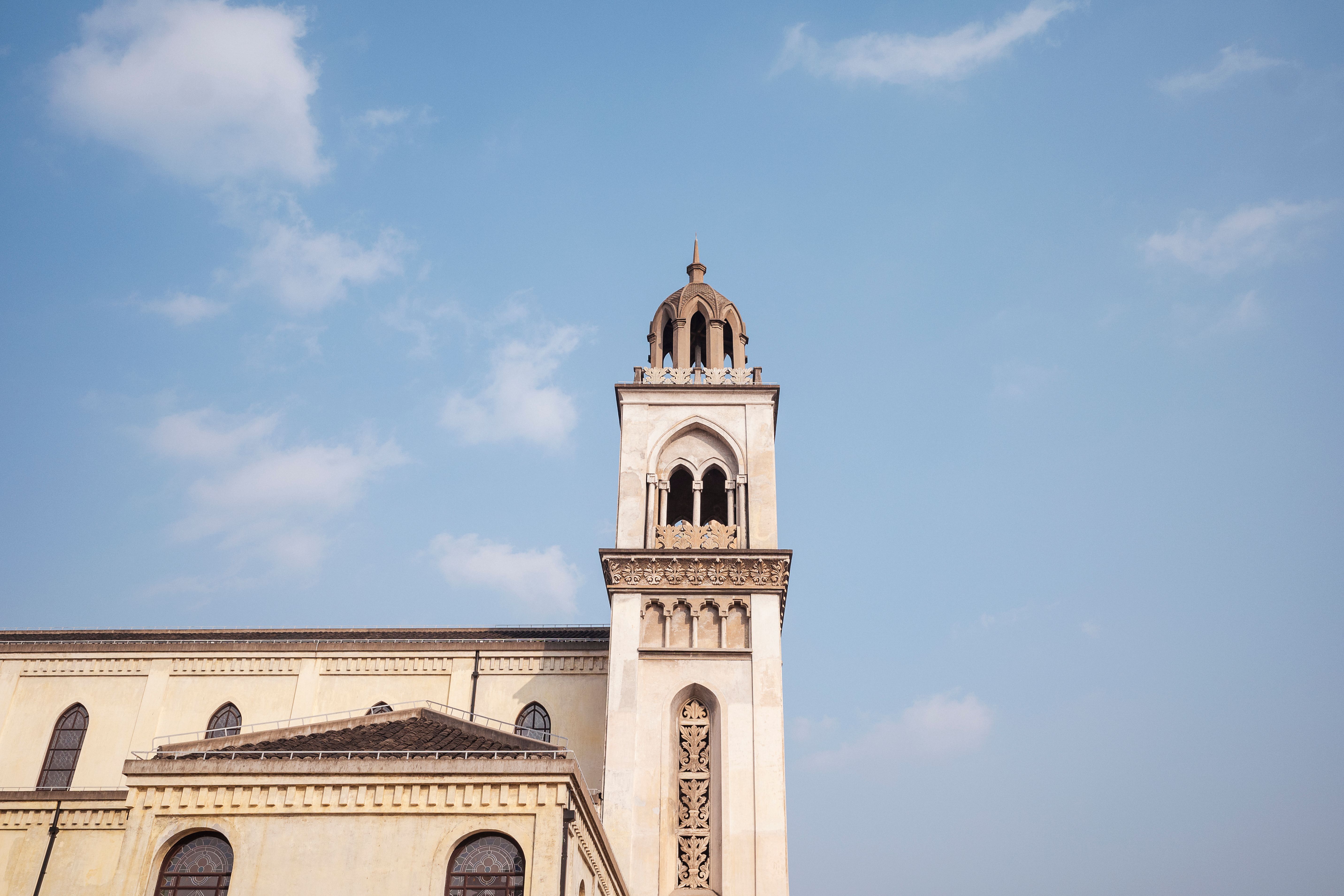 Historic Church Tower Against Clear Blue Sky · Free Stock Photo