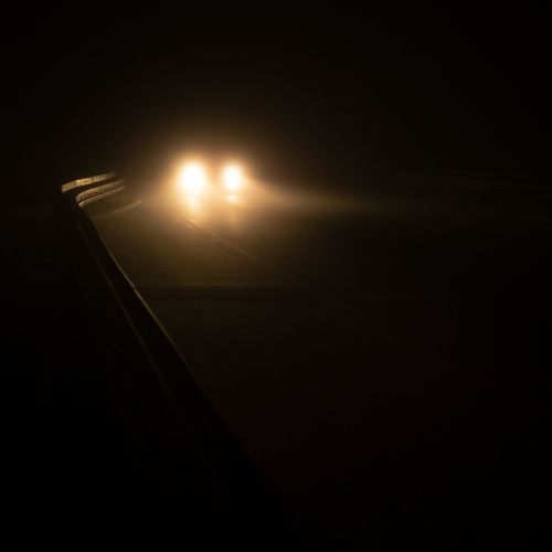 Headlights on an empty road at night, by Alex Fu on Pexels