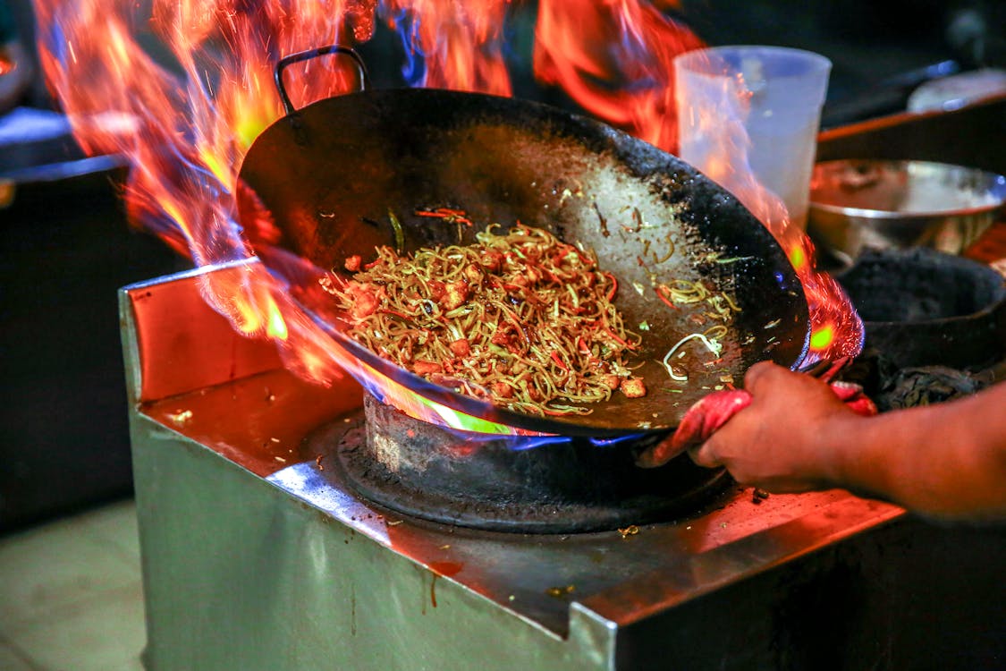 noodles cooking in a wok