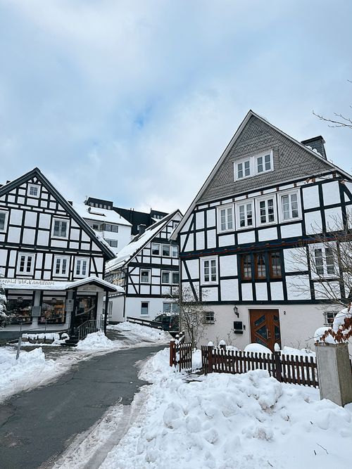 Free Charming snowy village with traditional half-timbered architecture in winter. Stock Photo