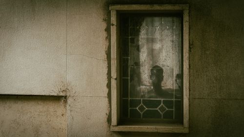 Free Haunting silhouette in a stained glass window at a cemetery in Rosario, Argentina. Stock Photo
