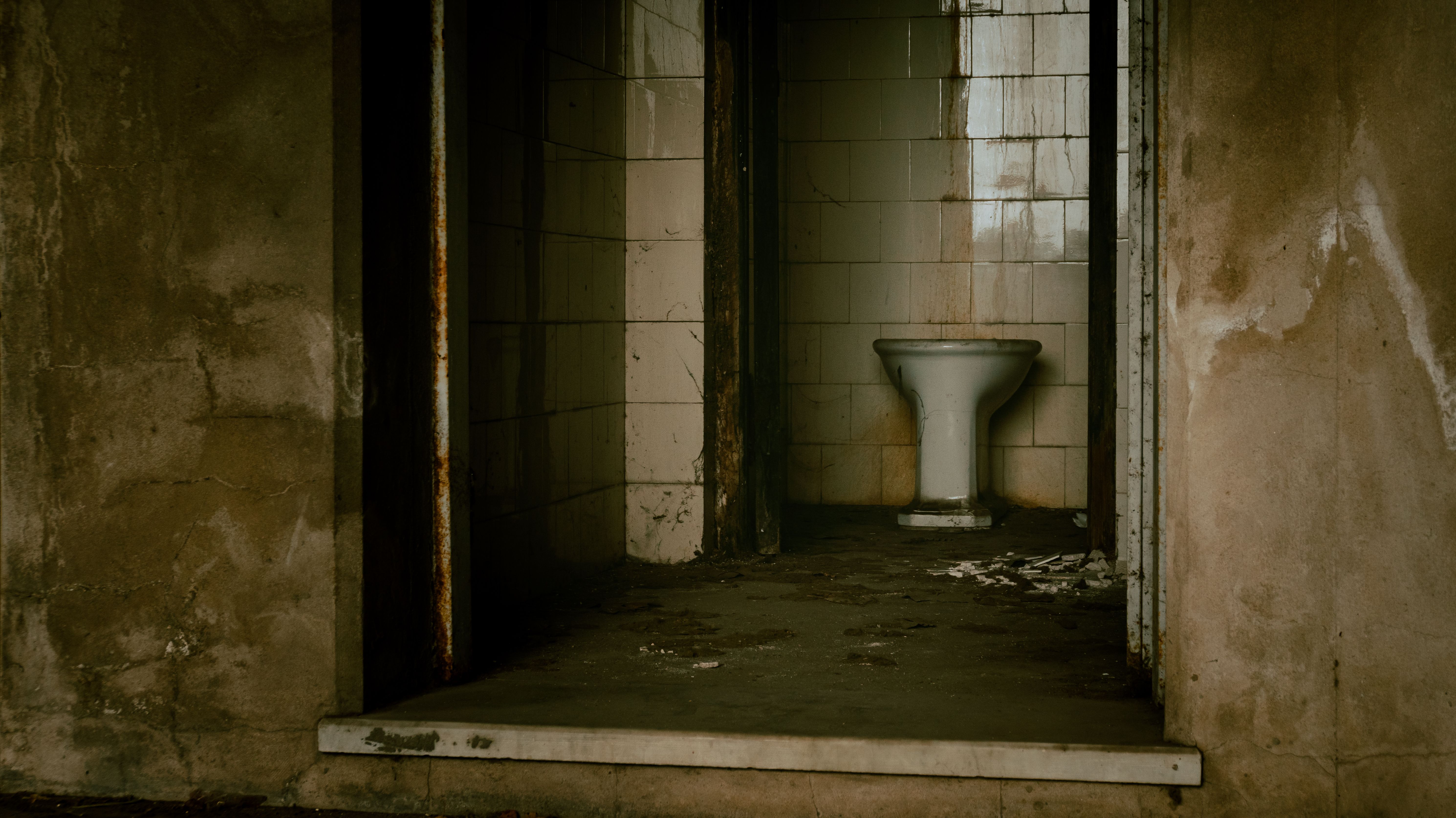 Explore the eerie ambiance of an abandoned bathroom setting in Argentina.