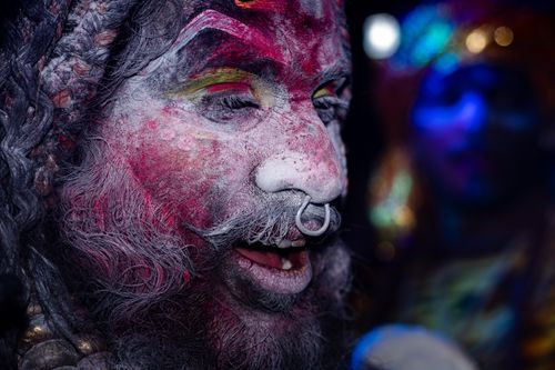 Free Close-up of a painted face during a vibrant cultural celebration at night. Stock Photo