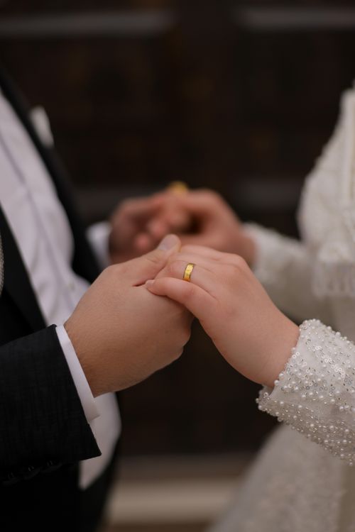 Free Close-up of a bride and groom holding hands, showcasing wedding rings. Stock Photo